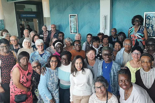NHS Retirement Fellowship members of the St George’s, Merton, and Wandsworth branch gathered together in a large group, all smiling at the camera.